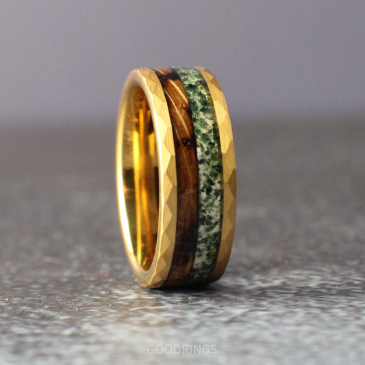 Gold ring with textured, hammered edges and split inlay of whiskey barrel and moss agate; meaningful wedding band for nature lovers.