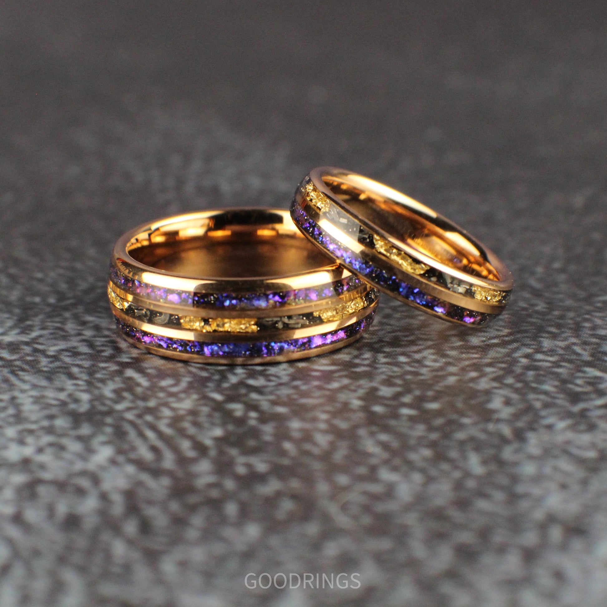 Close-up of a rose gold ring featuring a striking inlay of opals that shimmer in shades of blue and purple, paired with a textured meteorite strip, creating a celestial and elegant design.